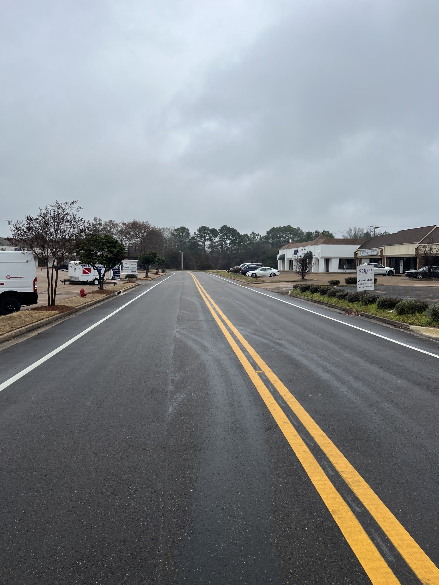 Yellow center line and white edge line road striping in commercial area Ridgeland Ridgeland